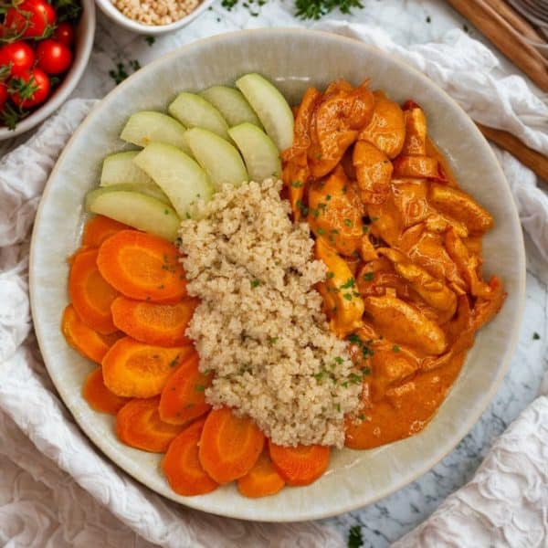 Chicken with paprika sauce, kohlrabi, quinoa, and carrots.